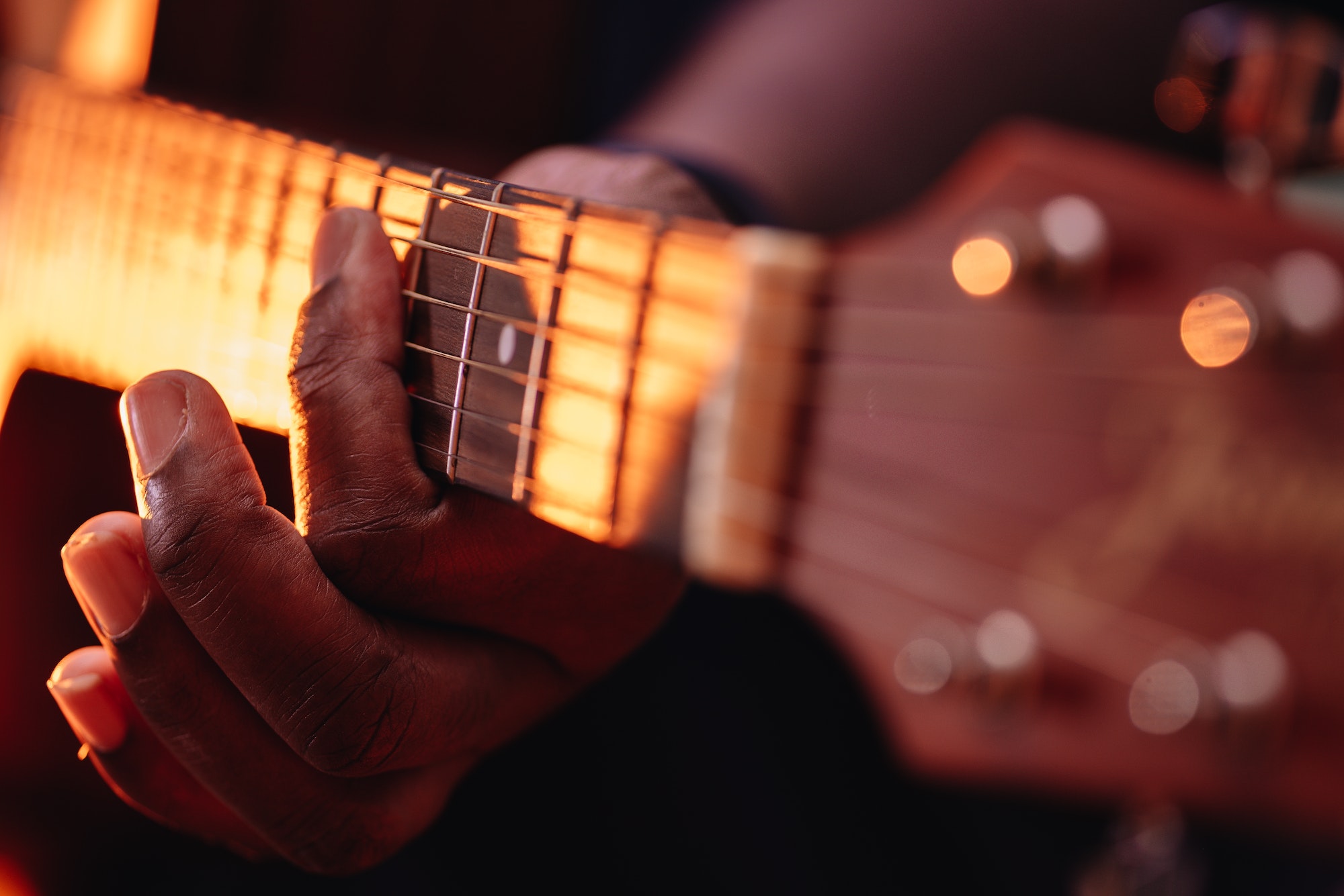 close-up-of-african-american-or-black-man-playing-an-acoustic-guitar.jpg